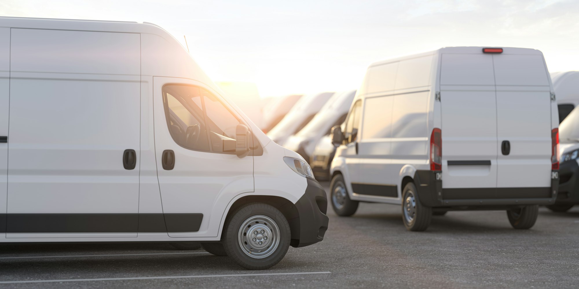 Express delivery, shipping service concept. Delivery vans in a row in the rays of sunset or dawn.